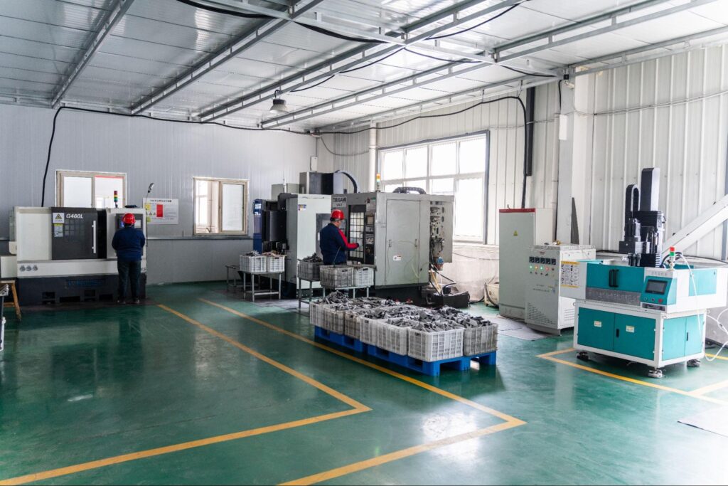 Inside Bunty LLC with two workers operating CNC machines

