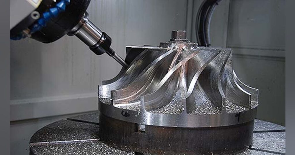 Close-up of CNC machine milling a complex metal impeller component
