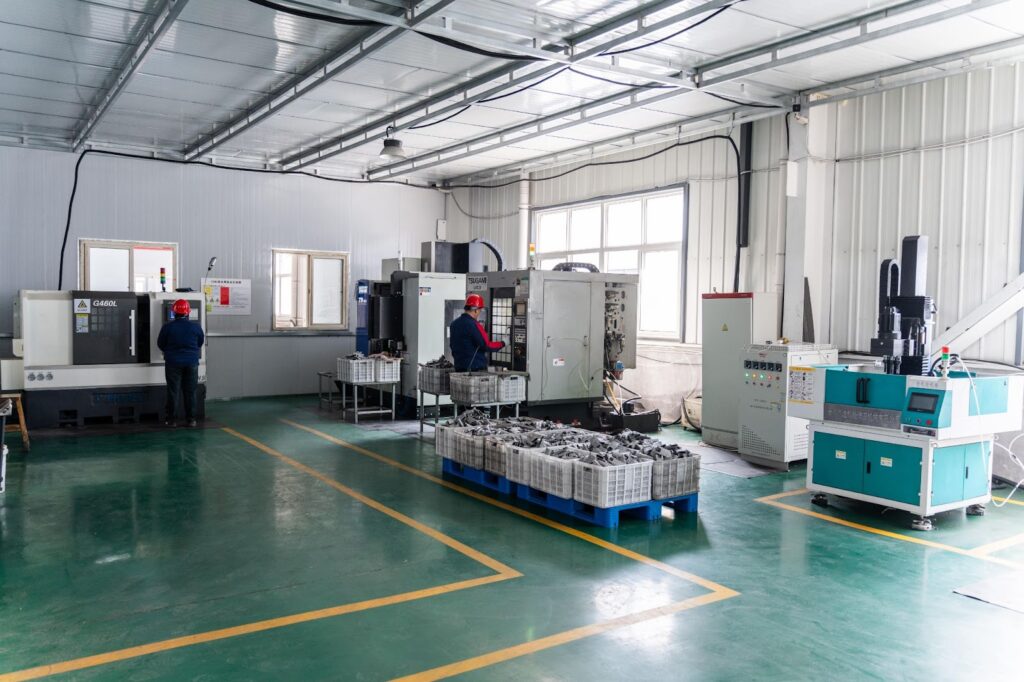 Inside Bunty LLC with two workers operating CNC machines