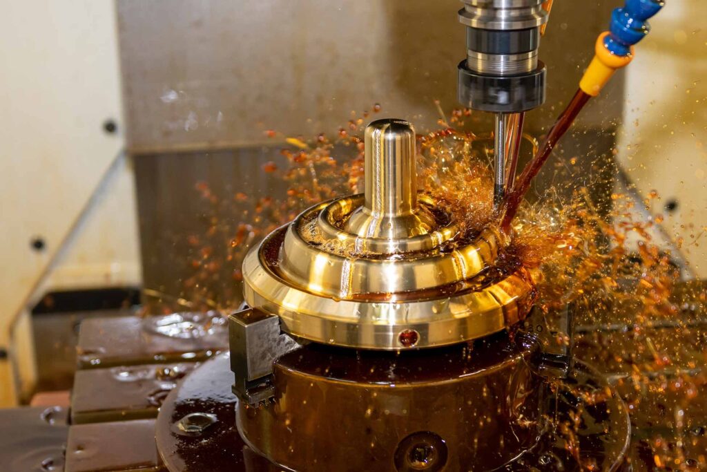 CNC milling machine cutting a metal part with coolant fluid splashing around